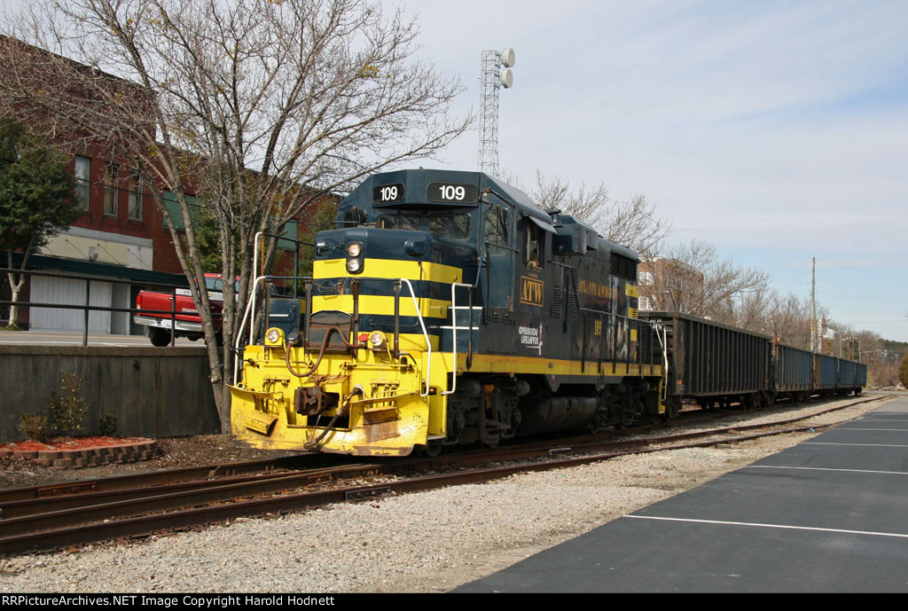 ATW 109 leads a short train thru town